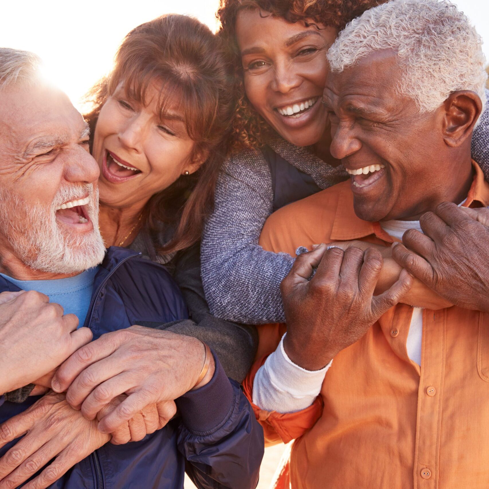 Smiling Senior Friends Having Fun Walking In Countryside Together